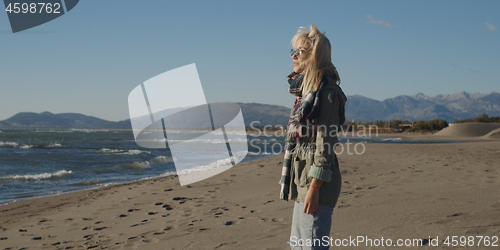 Image of Young woman enjoying the warm autumn day