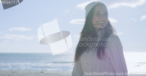 Image of Girl In Autumn Clothes Smiling on beach