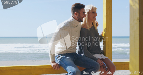 Image of Couple chating and having fun at beach bar