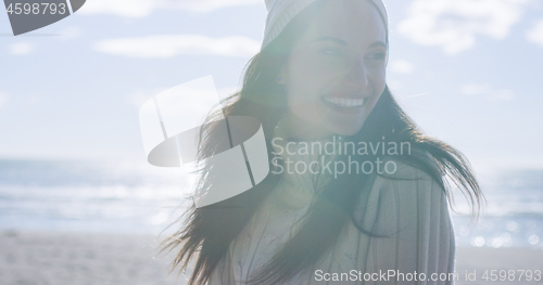 Image of Girl In Autumn Clothes Smiling on beach