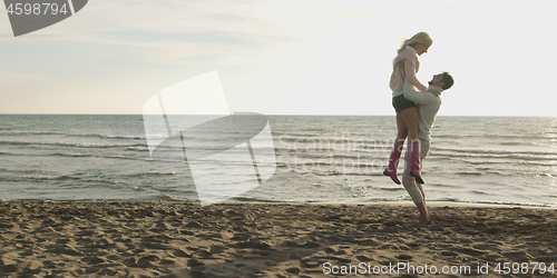 Image of Loving young couple on a beach at autumn on sunny day