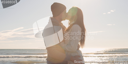 Image of Couple having fun on beautiful autumn day at beach