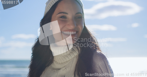 Image of Girl In Autumn Clothes Smiling on beach