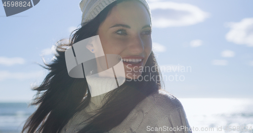 Image of Girl In Autumn Clothes Smiling on beach