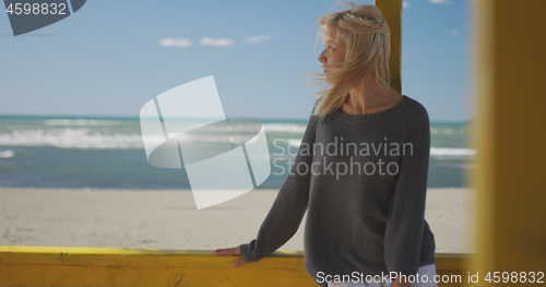 Image of Young woman enjoying the warm autumn day