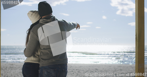 Image of Couple having fun on beautiful autumn day at beach