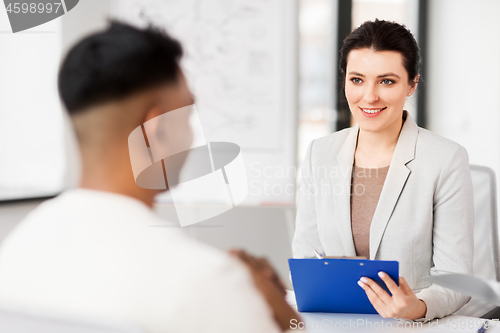 Image of employer having interview with employee at office