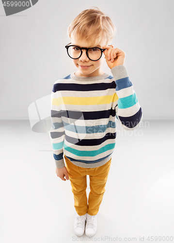 Image of smiling boy in glasses and striped pullover