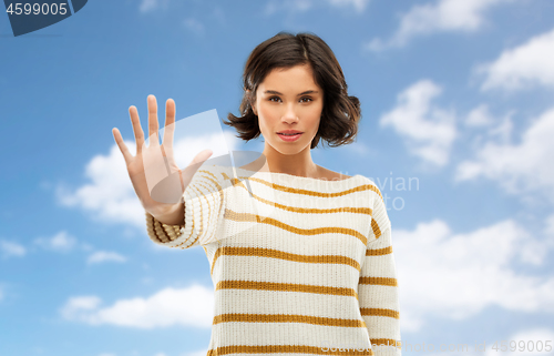 Image of young woman making stopping gesture