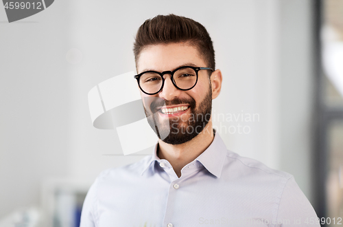 Image of portrait of smiling bearded businessman in glasses