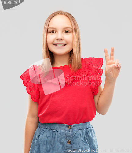 Image of beautiful smiling girl showing peace sign
