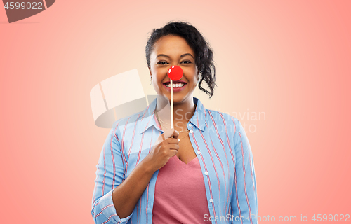 Image of happy african american woman with red clown nose