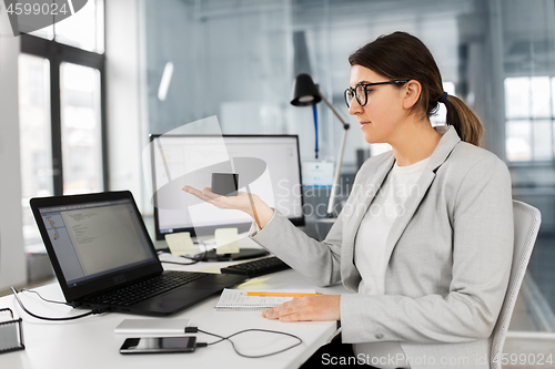 Image of businesswoman using smart speaker at office