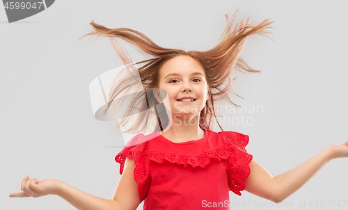 Image of happy girl in red shirt with waving hair