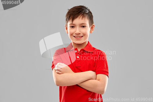 Image of smiling boy in red t-shirt with crossed arms