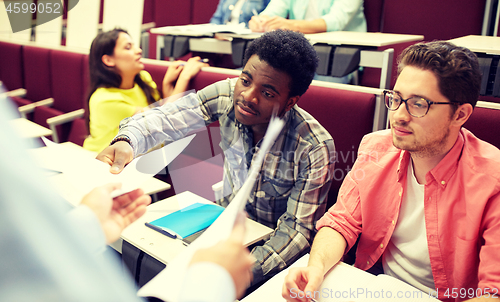 Image of teacher giving tests to students at lecture