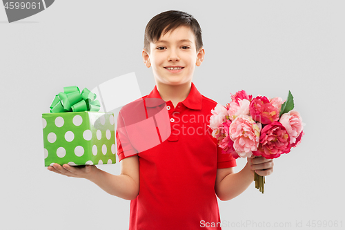 Image of smiling boy with birthday gift box and flowers