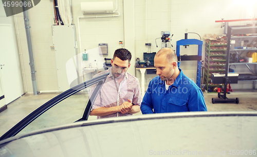 Image of auto mechanic and man at car shop