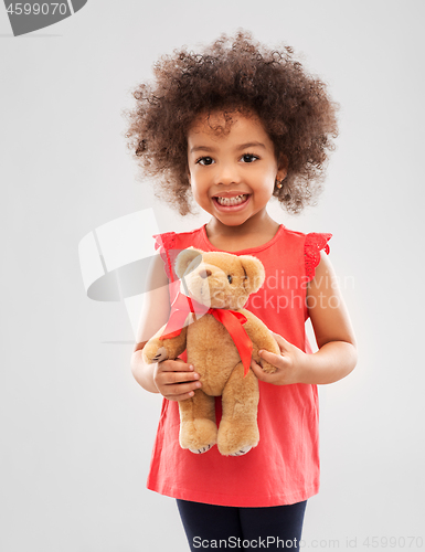 Image of happy little african american girl with teddy bear