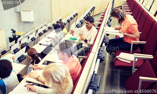 Image of group of students writing test at lecture hall