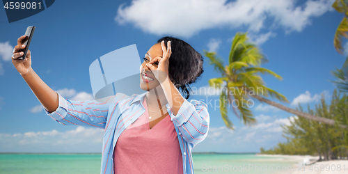 Image of african american woman taking selfie by smartphone