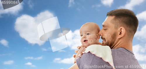 Image of father with little baby girl over blue sky