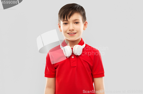 Image of smiling boy in red t-shirt with headphones on neck