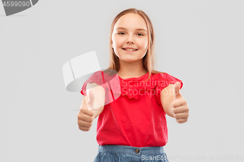 Image of beautiful smiling girl showing thumbs up