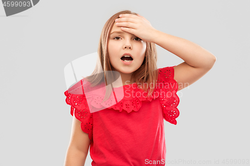 Image of shocked girl holding to her head