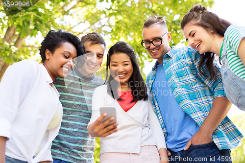 Image of happy friends with smartphone at summer park