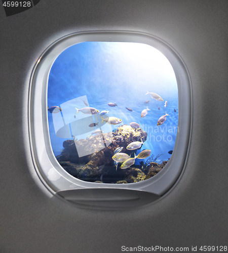 Image of View of cloudy blue clear sky through airplane porthole.