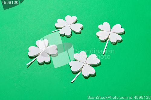 Image of Papercraft composition of white shamrock\'s leaves.