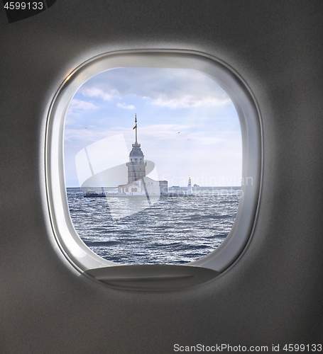 Image of Aerial view of cloudy sky through airplaine window.