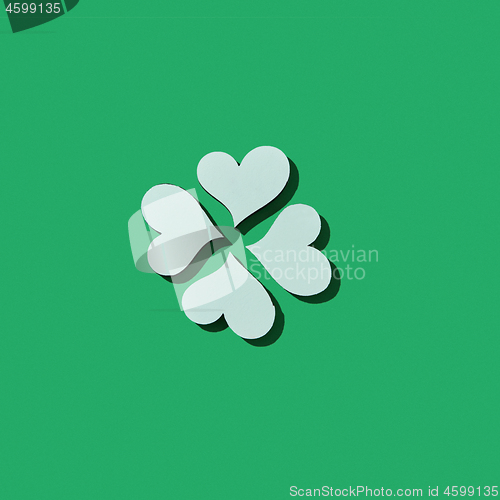 Image of Handcraft paper white clover\'s four petals with shadows.