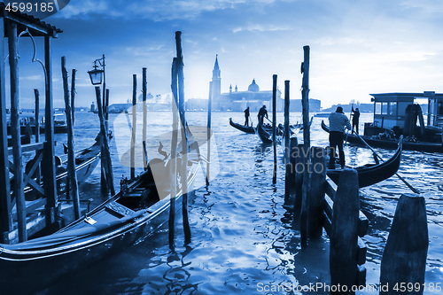 Image of Venetian Gondolas in Italy, sunset behind San Giorgio Maggiore c