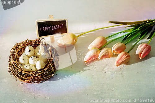 Image of Easter eggs and tulips on wooden planks