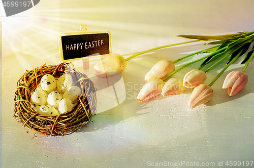 Image of Easter eggs and tulips on wooden planks