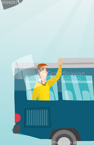 Image of Young caucasian man waving hand from bus window.