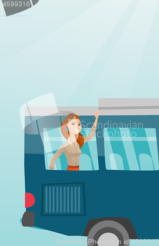 Image of Young caucasian woman waving hand from bus window.