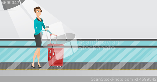 Image of Woman using smartphone on escalator at the airport