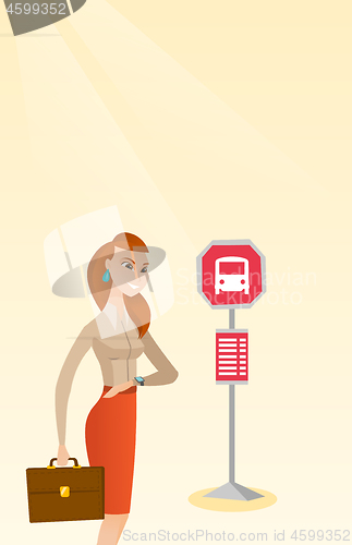 Image of Caucasian woman waiting for a bus at the bus stop.