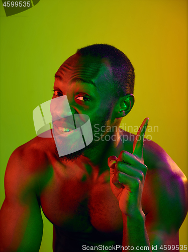 Image of Close up portrait of a young naked african man looking at camera indoors