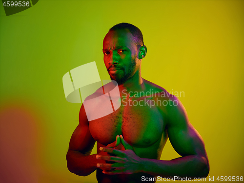 Image of Close up portrait of a young naked african man looking at camera indoors