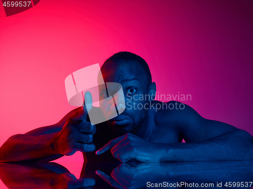 Image of Close up portrait of a young naked african man looking at camera indoors