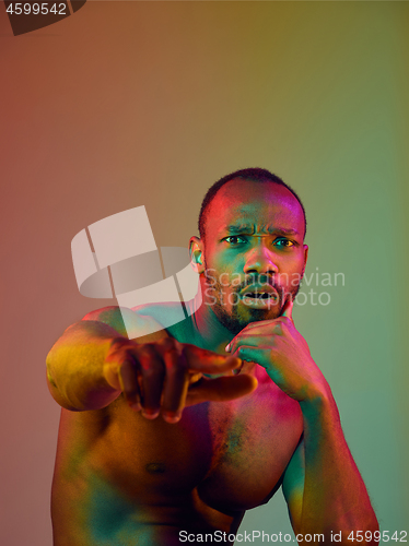 Image of Close up portrait of a young naked african man looking at camera indoors