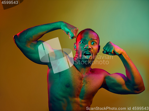 Image of Close up portrait of a young naked african man looking at camera indoors