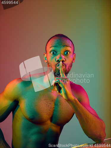 Image of Close up portrait of a young naked african man looking at camera indoors