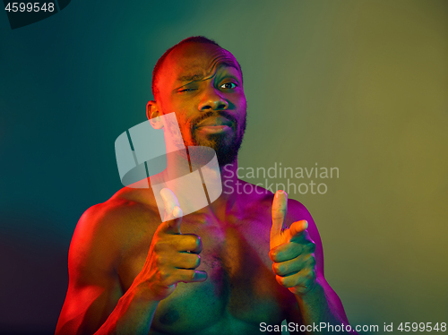 Image of Close up portrait of a young naked african man looking at camera indoors