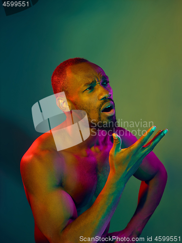 Image of Close up portrait of a young naked african man looking at camera indoors