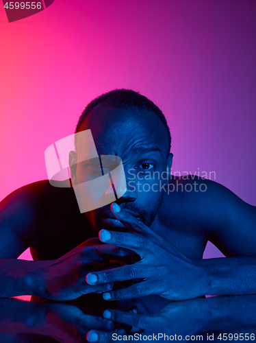 Image of Close up portrait of a young naked african man looking at camera indoors